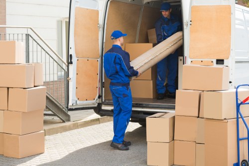 Man with van loading furniture in Seven Kings near residential properties